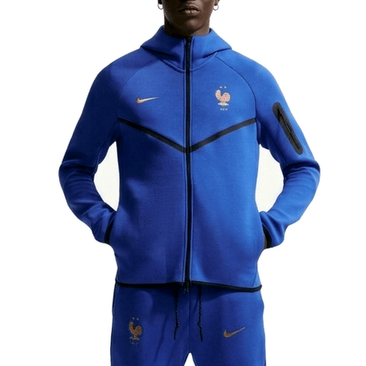 Authentic Nike France Tech Fleece presentation soccer tracksuit 2026/27 in blue for adults with zippered pockets and logo.
