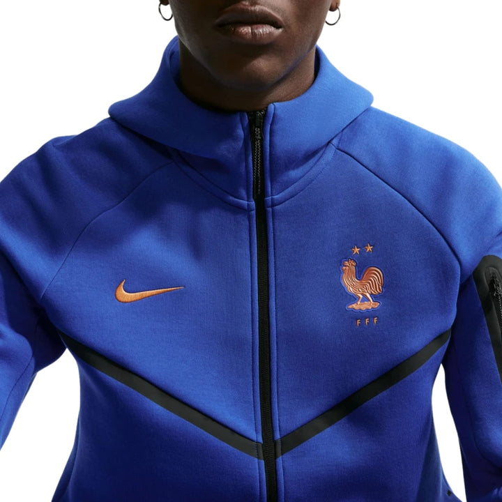 France Tech Fleece presentation soccer tracksuit  2026/27 in blue with orange Nike logo and France emblem for adults
