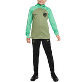 Kids Atletico Madrid tracksuit with green zip-up jacket and black pants featuring soccer logos