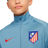 Close-up of a boy wearing a blue kids Atletico Madrid tracksuit jacket with Nike logo