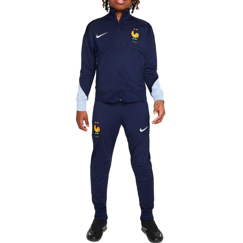 Kids wearing navy blue kids France soccer tracksuit 2024 with yellow rooster emblem and Nike logos