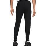 Liverpool FC black tech fleece pants back view on model tapered fit with ribbed cuffs and sneakers