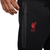 Liverpool FC black tech fleece pants close up showing red LFC crest zippered side pocket and drawstring