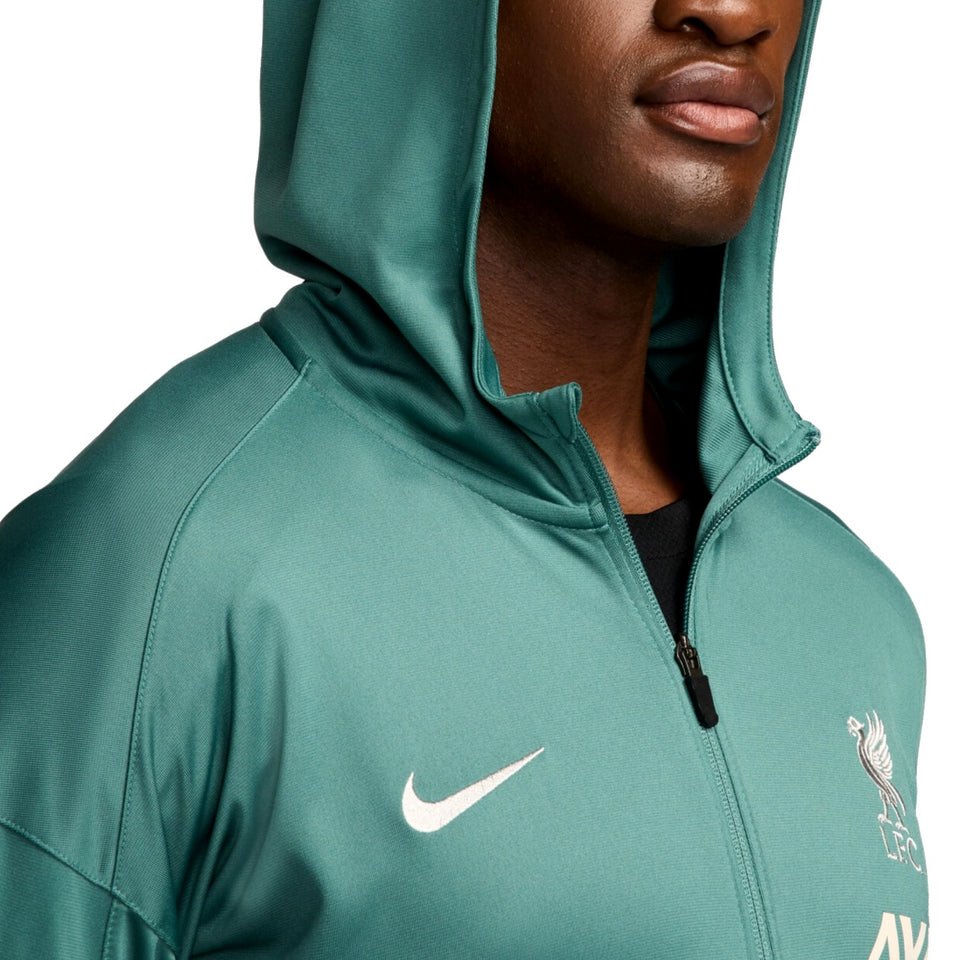 Close-up of green Liverpool FC presentation tracksuit 2024 25 hoodie with Nike logo and team crest