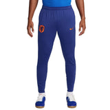Blue Nike Netherlands training tracksuit pants with orange logo and Nike swoosh on SoccerTracksuits.com