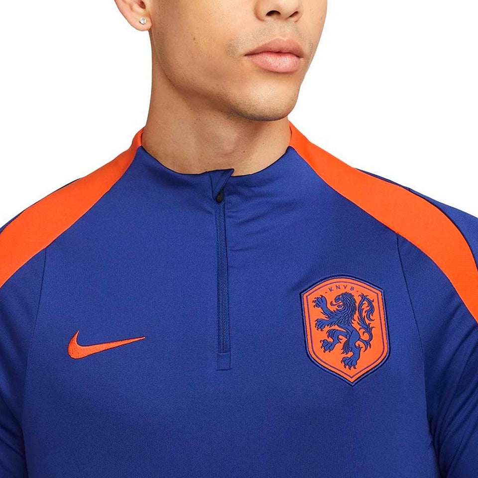Close-up of Nike Netherlands training tracksuit top with orange accents and embroidered lion crest