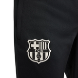 Close-up of official kids Nike Barca tracksuit black pants with FCB logo on SoccerTracksuits.com