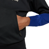 Close-up of hand in pocket on official kids Nike Barca tracksuit with black and blue color blocks