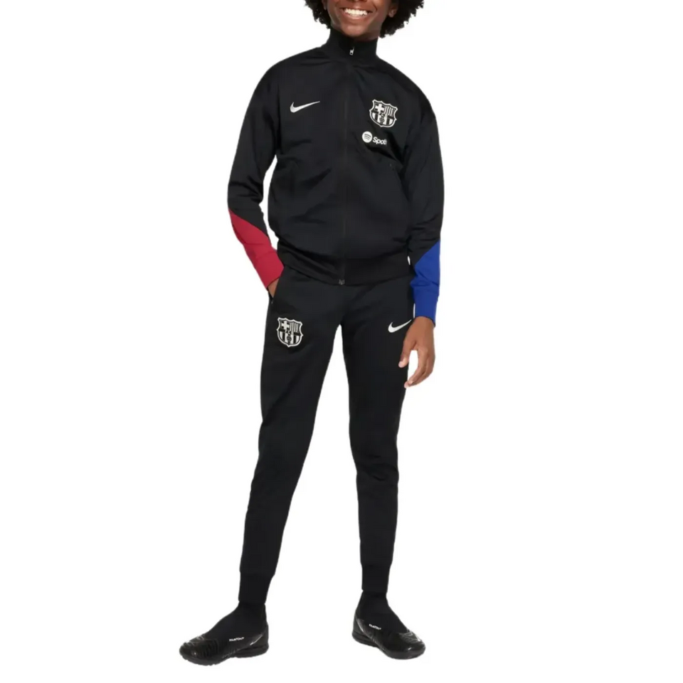 Official kids Nike Barca tracksuit in black with red and blue sleeve accents and club logo