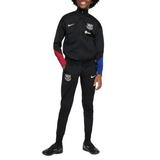 Official kids Nike Barca tracksuit in black with red and blue sleeve accents and club logo