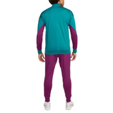 Back view of official PSG Nike tracksuit 2024 in teal and purple with white sneakers