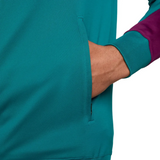 Close-up of pocket and sleeve cuff on official PSG Nike tracksuit 2024 in teal and purple