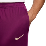 Close-up of purple official PSG Nike tracksuit 2024 pants with white Nike logo and elastic waistband