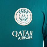 Close-up of official PSG Nike tracksuit 2024 logo and Qatar Airways sponsor on teal fabric