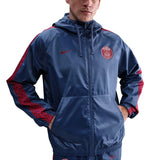 Model wearing Paris Saint-Germain woven tracksuit men's navy hooded jacket with red patterned sleeve stripes