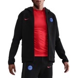 Nike PSG black Tech Fleece tracksuit 2025 26 featuring a hoodie and matching pants on SoccerTracksuits.com
