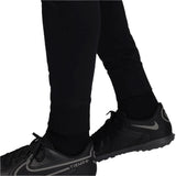 Close-up of black pants from PSG Champions League tracksuit worn with black Nike Tiempo shoes