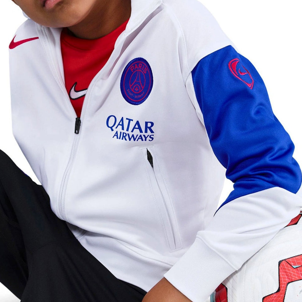Nike PSG kids soccer tracksuit 2025 in white and blue with Qatar Airways logo on SoccerTracksuits.com