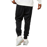 Back view of black track pants and white sneakers model wearing PSG Nike Total 90 tracksuit 2025 26