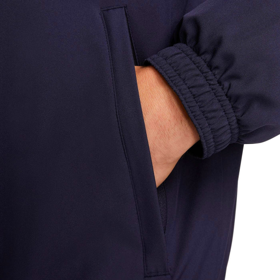 Close-up of navy blue Nike PSG soccer tracksuit for men showing elastic cuff and side pocket