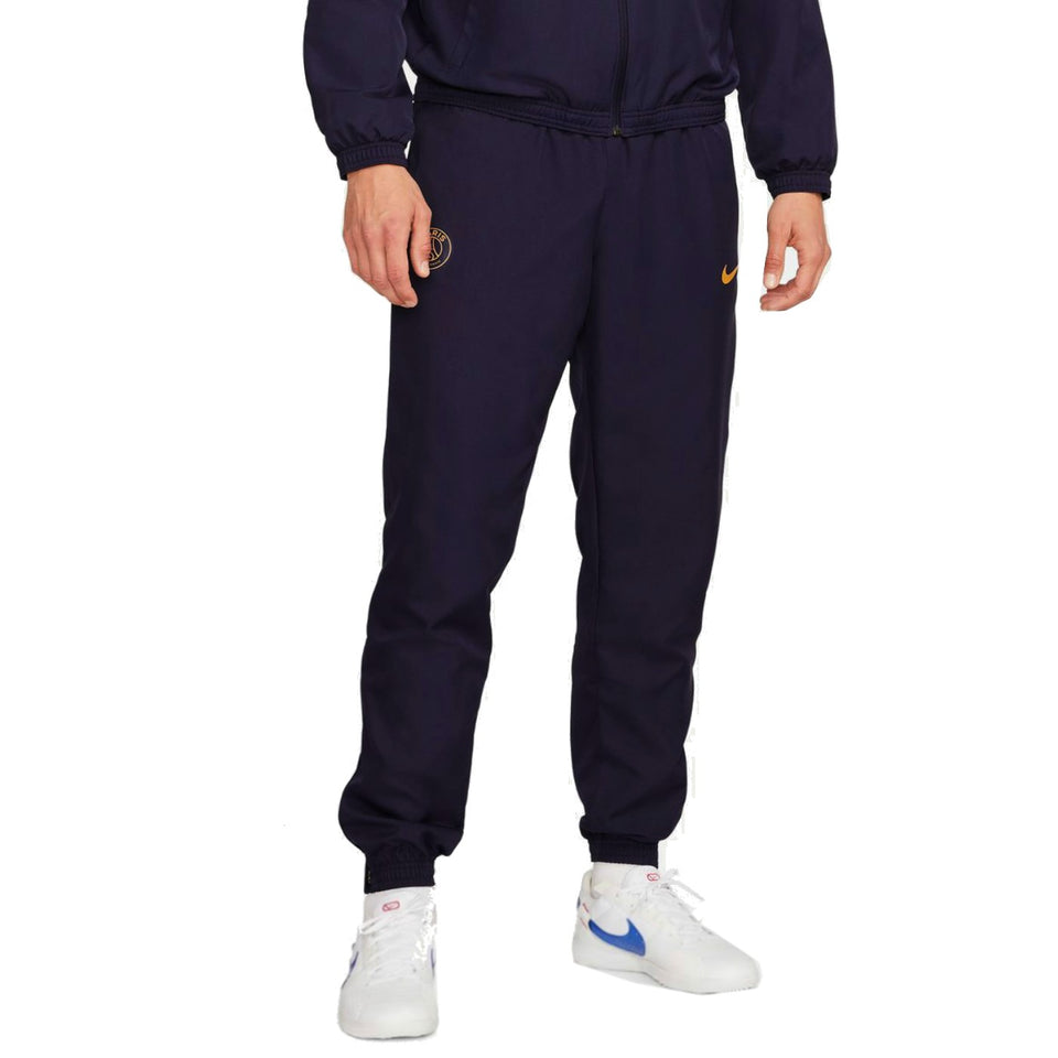 Nike PSG soccer tracksuit for men in navy blue with orange logo and elastic cuffs