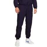 Nike PSG soccer tracksuit for men in navy blue with orange logo and elastic cuffs