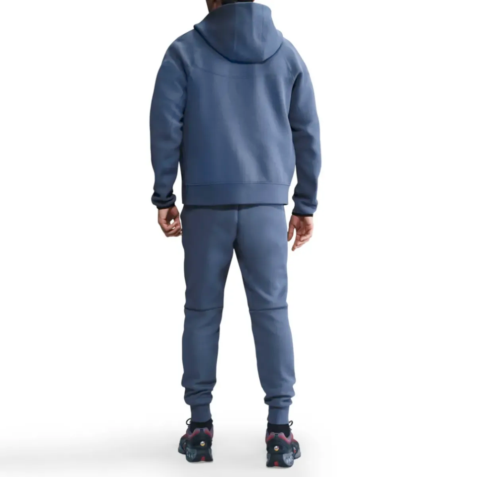 Back view of a man wearing PSG Tech Fleece tracksuit 2025 26 in blue, ideal for casual wear on SoccerTracksuits.com