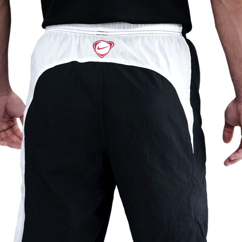 Back view of PSG Total 90 soccer tracksuit pants showing black and white design details