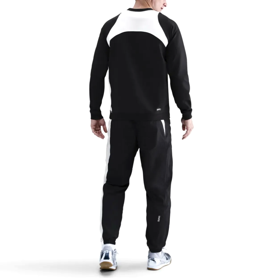 Back view of a man wearing a PSG Total 90 soccer tracksuit in black and white for ultimate comfort