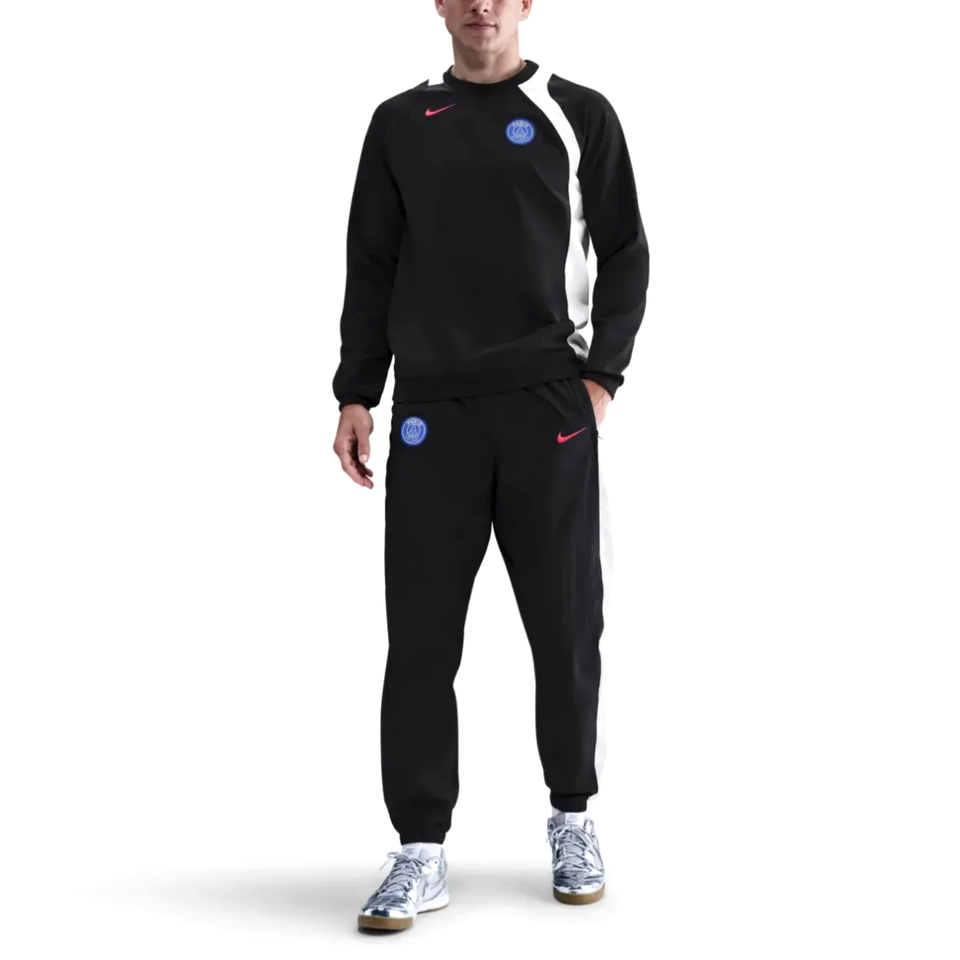 Nike PSG Total 90 soccer tracksuit in black, styled with matching pants and sweatshirt for athletic wear