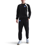 Nike PSG Total 90 soccer tracksuit in black, styled with matching pants and sweatshirt for athletic wear