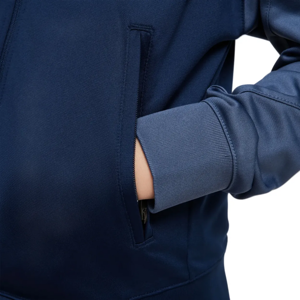 Close-up of blue Nike PSG training suit for kids 2025 showing pocket and sleeve details