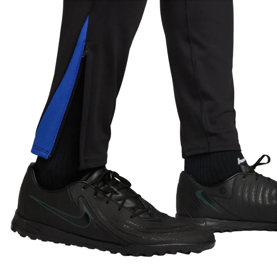 Close-up of Nike PSG UCL Total 90 tracksuit pants with zip pocket and blue detailing