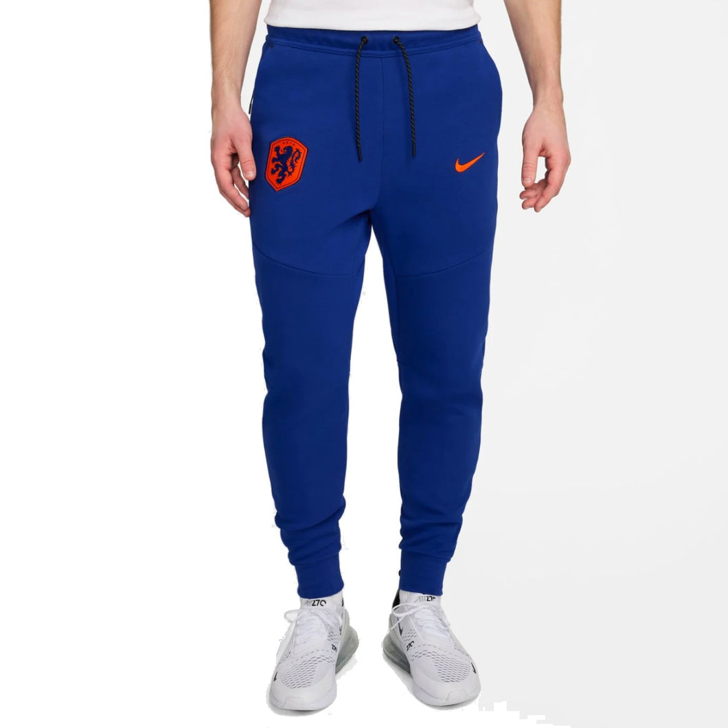 Blue Nike tech fleece tracksuit Netherlands pants with orange logo and white sneakers