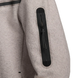 Close-up of sleeve pocket zipper on beige Tottenham Hotspur Tech Fleece tracksuit on SoccerTracksuits.com