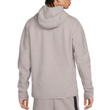 Back view of a person wearing gray Tottenham Hotspur Tech Fleece tracksuit with hood and long sleeves