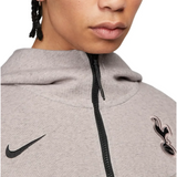 Close-up of grey Tottenham Hotspur Tech Fleece tracksuit hoodie with Nike logo and team emblem
