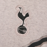Tottenham Hotspur Tech Fleece tracksuit close-up of embroidered club logo in black and white on gray fabric