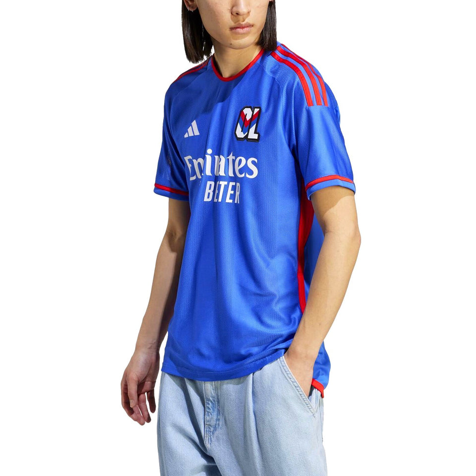 Stylish Olympique Lyon away jersey 2023 24 with blue design and vibrant red accents for soccer fans