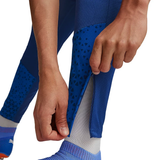 Close-up of a person adjusting the hem of the Olympique Marseille 2024 blue training tracksuit for optimal fit