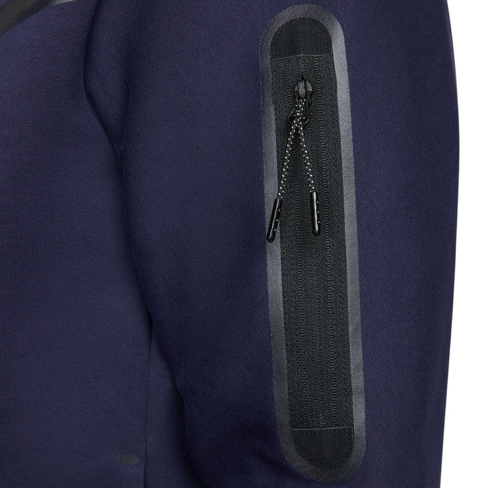 Close-up of a zippered arm pocket on navy PSG tech fleece tracksuit 2023 from SoccerTracksuits.com