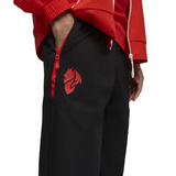 Puma AC Milan presentation suit 2025 26 featuring red jacket and black pants with logo detail