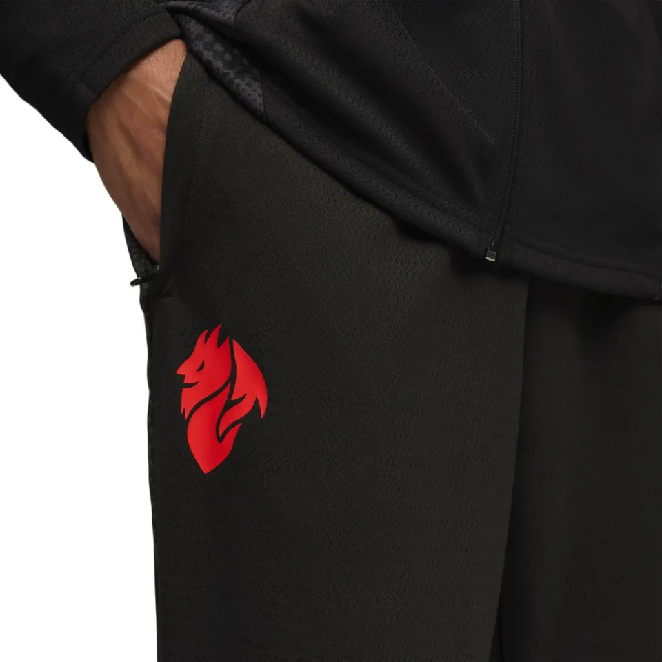 Puma AC Milan training tracksuit 2025 26 featuring sleek black pants with a vibrant red logo detail