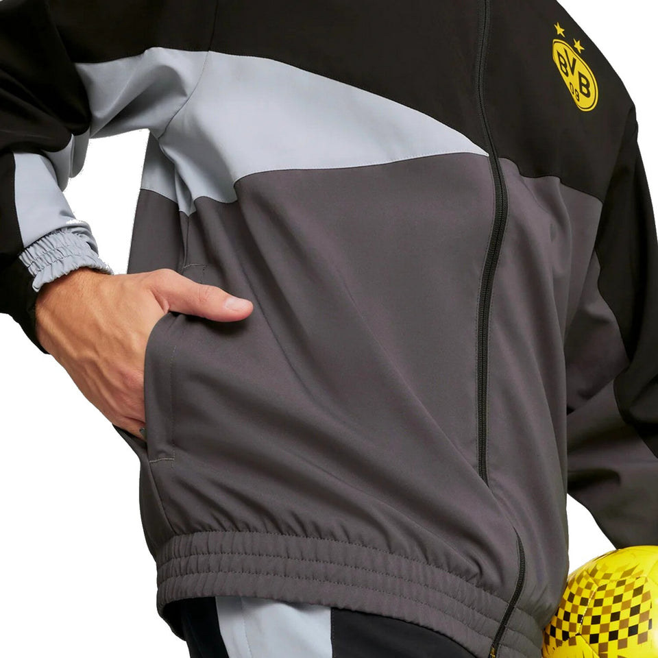 Close-up of Puma BVB woven presentation suit jacket in black, gray, and white with elastic cuffs and yellow BVB logo