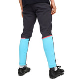 Back view of Puma Man City hooded tracksuit black pants with blue and pink accents worn with black cleats