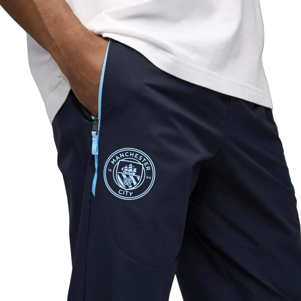 Close-up of Puma Manchester City presentation tracksuit featuring logo and zip pockets
