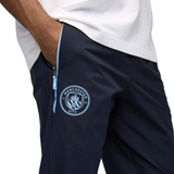Close-up of Puma Manchester City presentation tracksuit featuring logo and zip pockets