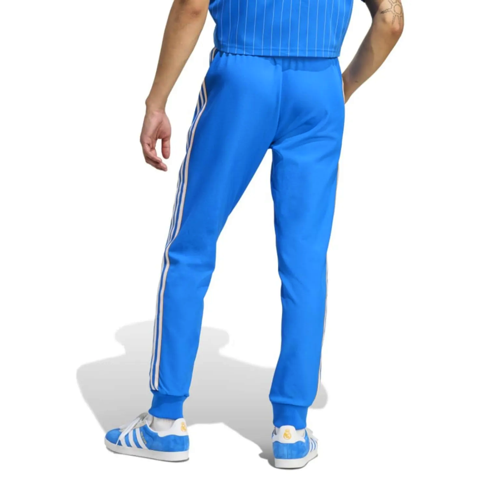 Back view of blue Real Madrid Adidas Originals tracksuit 2025 featuring iconic three stripes