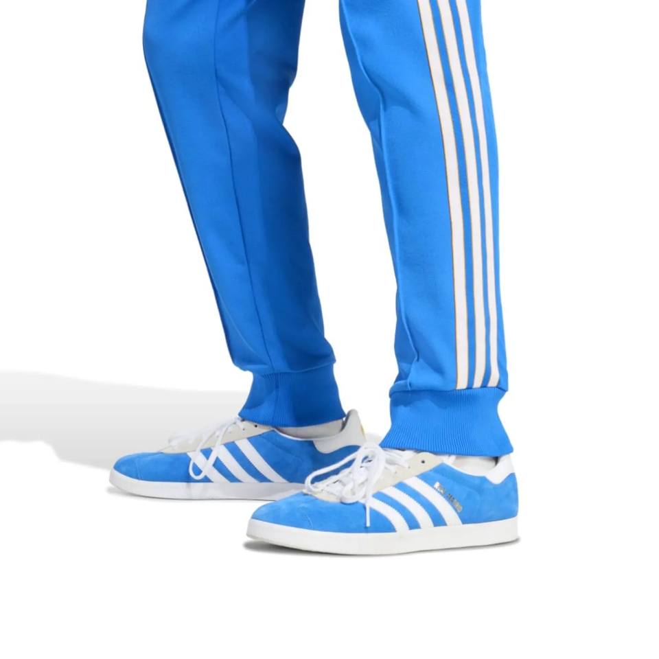 Blue Adidas Originals tracksuit 2025 with iconic stripes and matching shoes for real Madrid fans