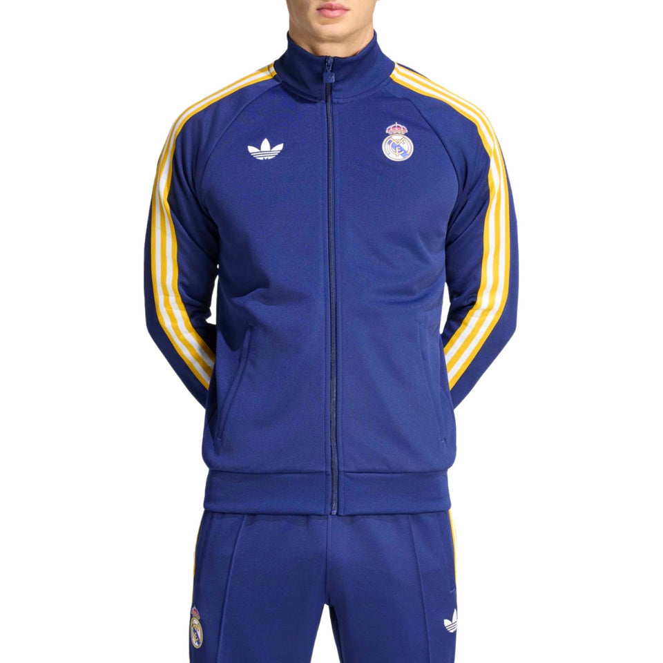 Navy blue Adidas Originals x Real Madrid tracksuit with gold stripes featuring Adidas logo on a white background